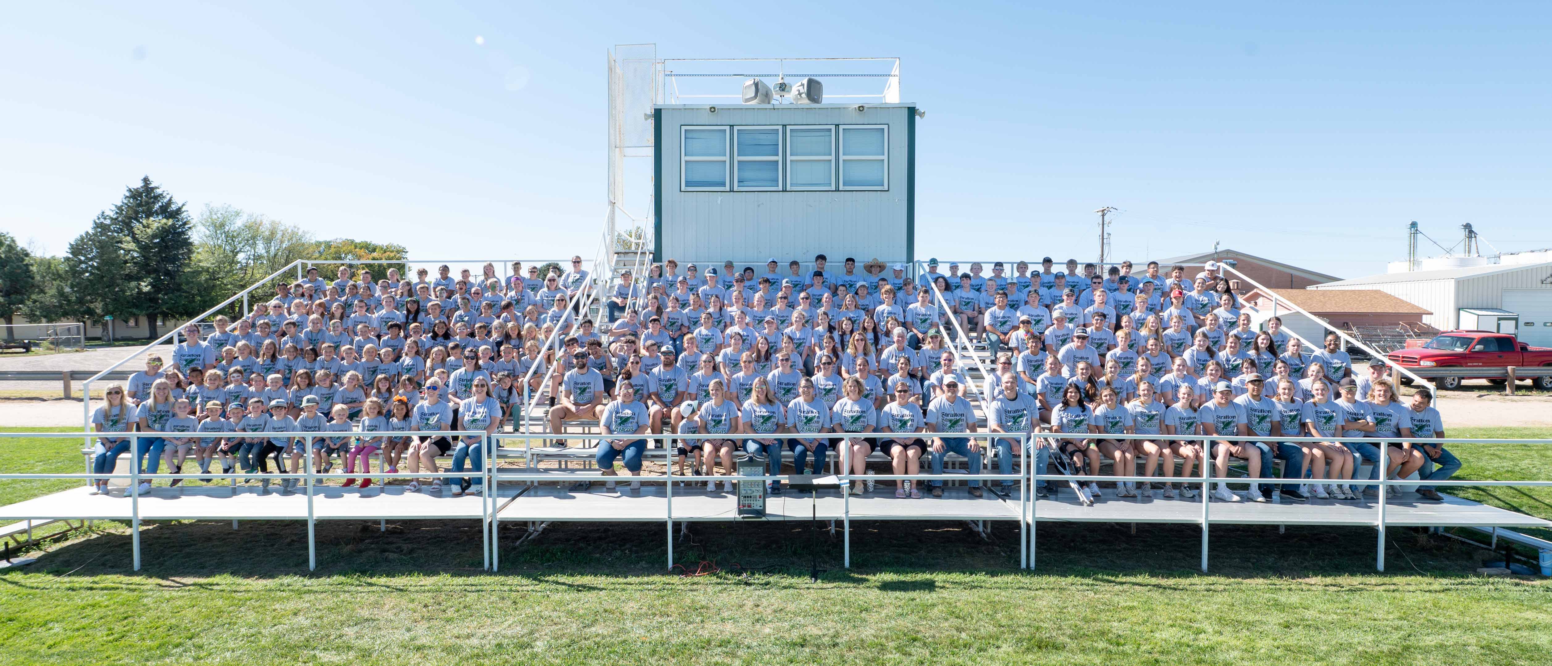 Picture of everyone in the district sitting on the football field bleachers